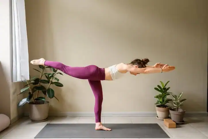 Woman doing Yoga exercise Dorset to help with toning the body. 